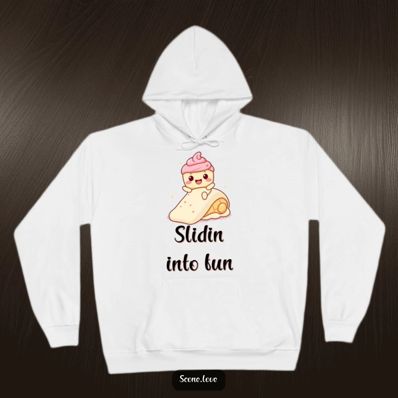 Funny Kawaii Scone with a wide smile, joyfully sliding down a frosting slide, printed on a warm hoodie.