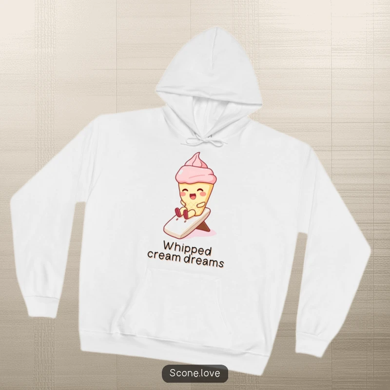 Funny hoodie with a kawaii scone character giggling while sliding down a generous swirl of whipped cream, cozy and amusing apparel.